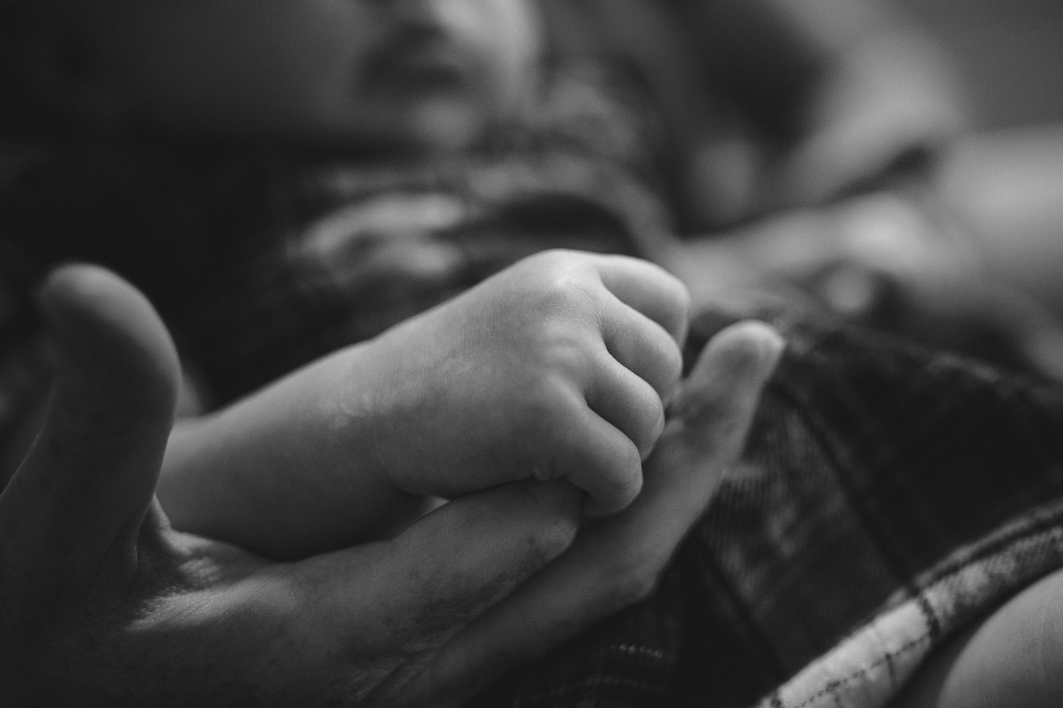 Baby holding mom's hand with little fingers