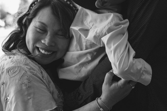 Mom hugs son during maternity photo session